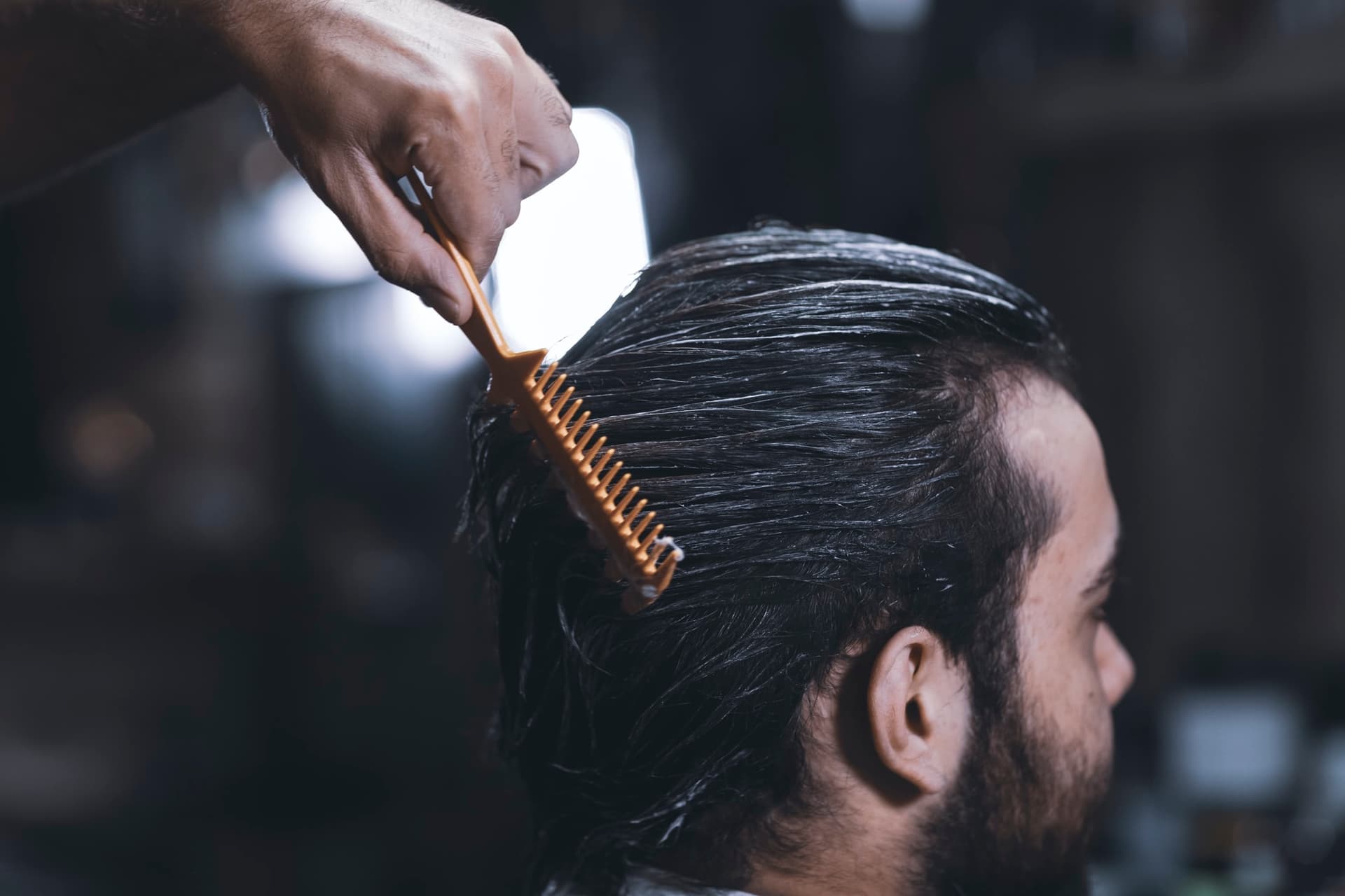 combing hair of barbershop client